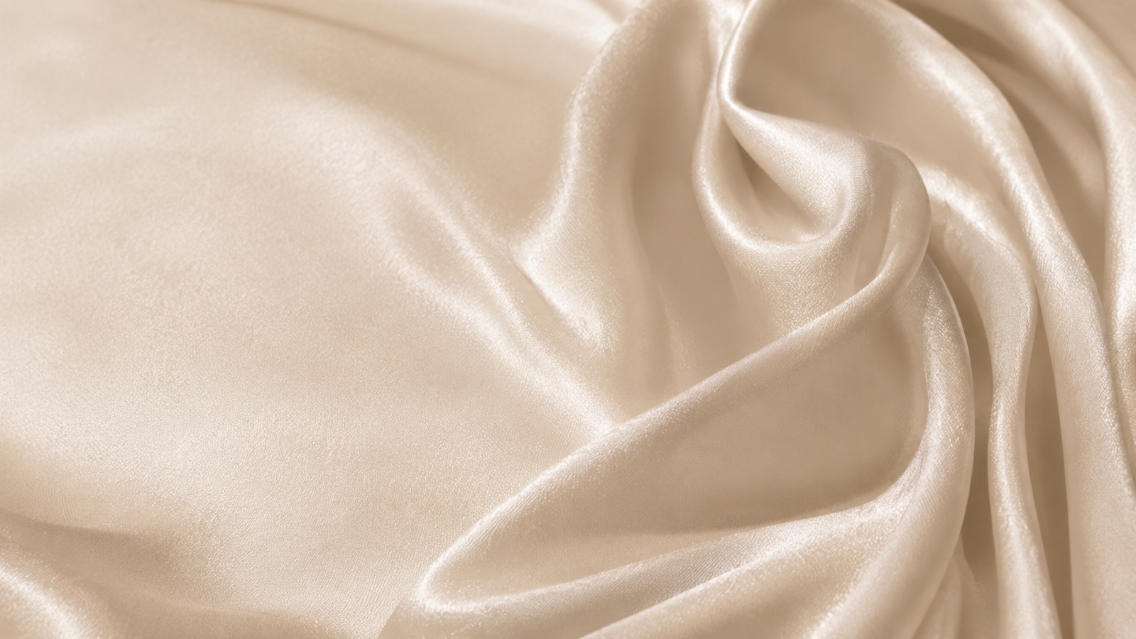 Close up of soft champagne mulberry silk, catching the light